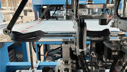 <p>The handle section feeds, positions and ultrasonically welds double soft loop handles onto both sides of the nonwoven material before cross-cutting. Handle length and spacing are configured according to the finished bag design.</p>
